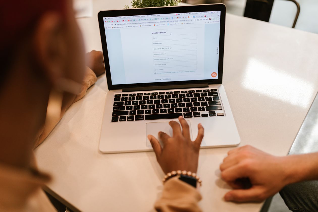 Personne remplissant un formulaire d'inscription en ligne sur un ordinateur portable